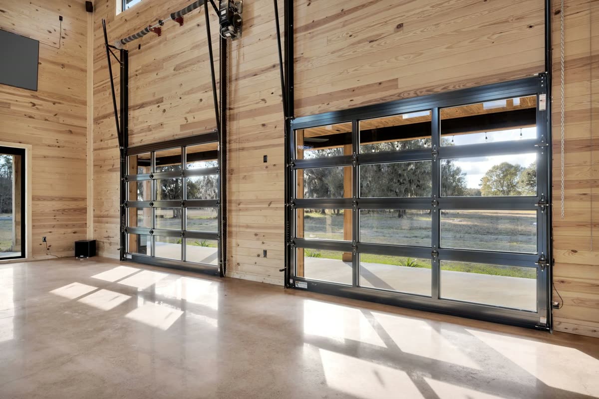 Full-height glass doors along the hall rolled open to the pasture, daylight across the polished floor