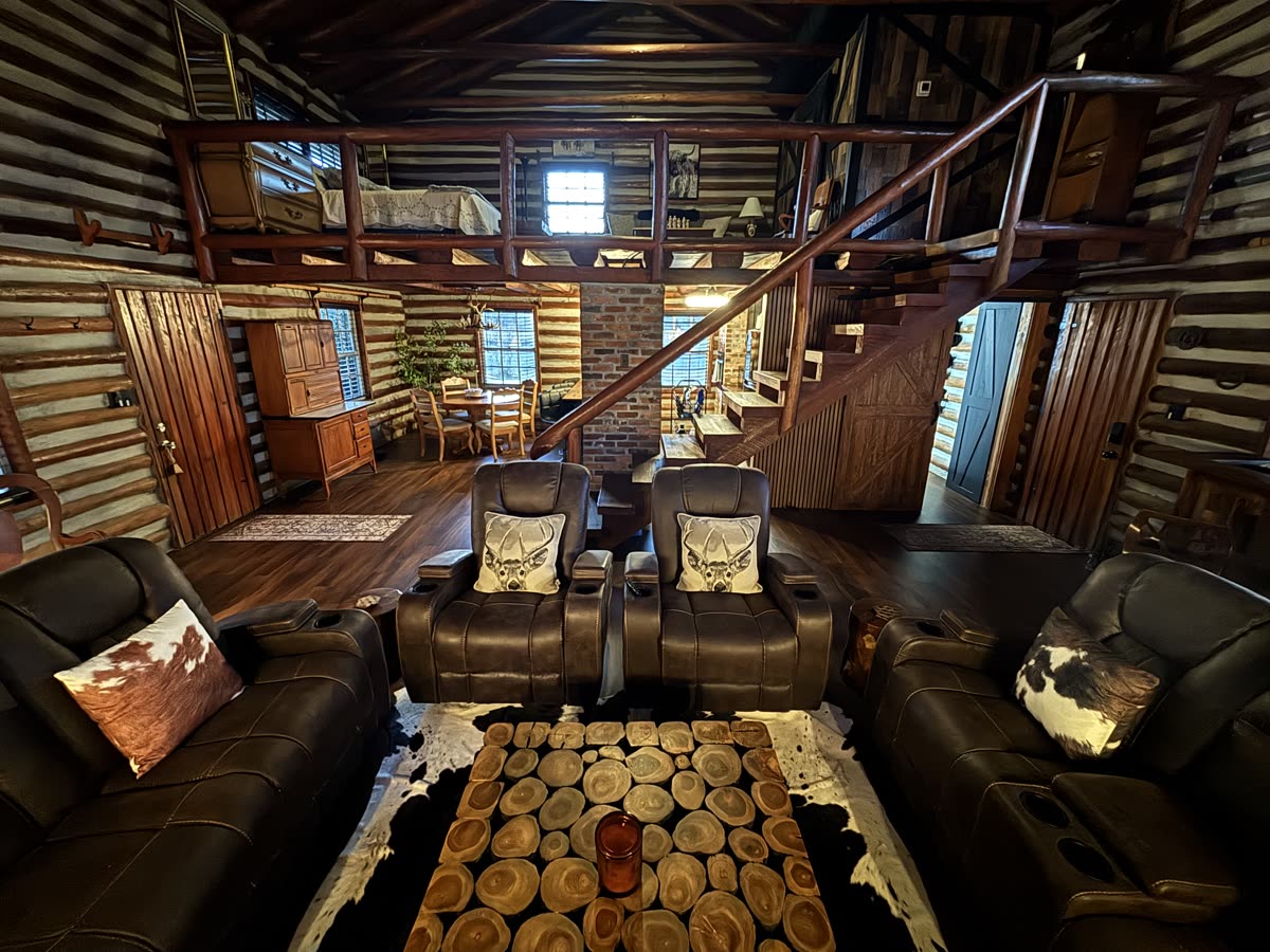 The Groom's Cabin lounge, with leather theater recliners under an open loft